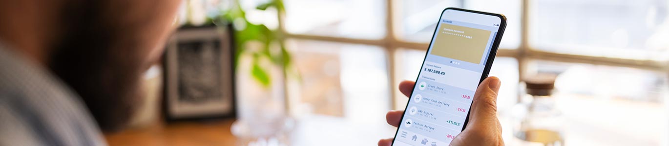 A man using his smartphone to view his bank account