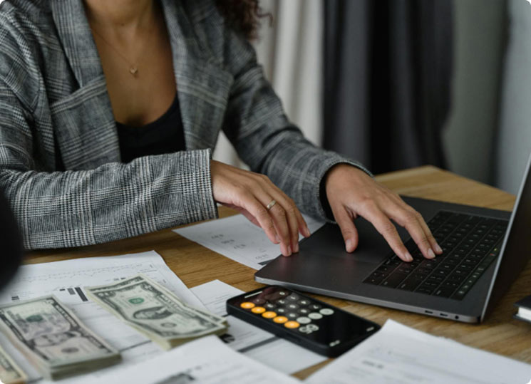 A lady using a laptop computer to manage her finances